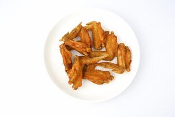delicious fried chicken wings on white plate on white background