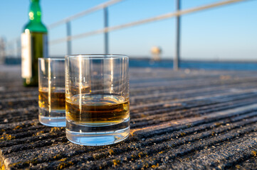 Drinking single malt Scotch whisky at sunset with sea, ocean or river view, private whisky tours in Scotland, UK