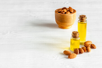 Bottle of almond oil with almond nuts. Extra virgin essence oil