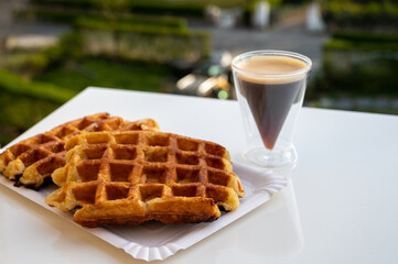 Belgian sugar waffles with black coffee served outdoor