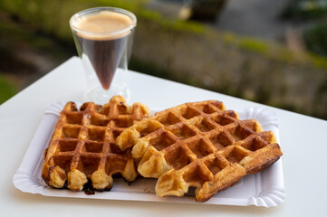 Belgian sugar waffles with black coffee served outdoor