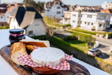 French breakfast with fresh baked baguette bread and camembert chees from Normandy, served outdoor with nice city view