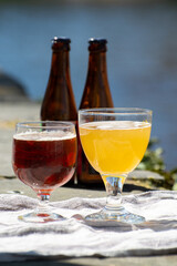 Tasting of Belgian beer on open cafe or bistro terrace with view on medieval houses and canals in Bruges, Belgium
