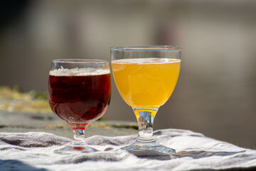 Tasting of Belgian beer on open cafe or bistro terrace with view on medieval houses and canals in Bruges, Belgium