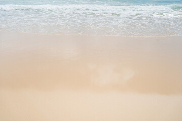 Fototapeta na wymiar Beautiful waves breaking onto sand.Top view of clear turquoise sea and foamy waves.