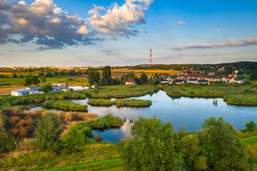 Beautiful scenery of the pond with amazing clouds before sunset, Poland