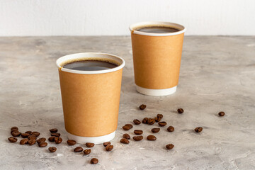 Black coffee in paper cups with beans. Take away coffee background