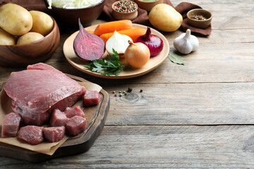 Fresh ingredients for borscht on wooden table