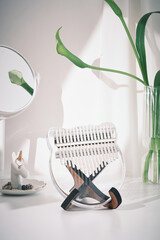 Kalimba or mbira is an African musical instrument. Glass Kalimba 17 keys on stand and on decoration white table with green leaves. Concept style. Music concept