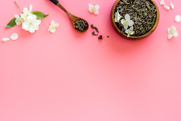 Obraz na płótnie Canvas Jasmine hearbal tea in bowl with flowers. Overhead view