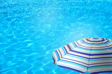 Obraz premium Open beach umbrella and swimming pool. Summer vacation