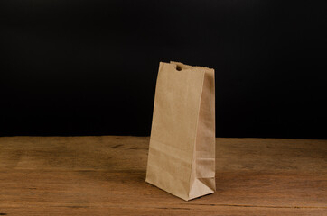 Brown paper bag on wooden board - 451976160