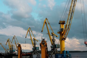 yellow cranes in the cargo river port. coal for loading into the freight train. Port in Vyborg on the Gulf of Finland