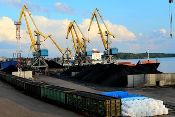 yellow cranes in the cargo river port. coal for loading into the freight train. Port in Vyborg on...