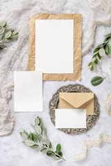 Wedding blank cards laying on a marble table decorated with eucalyptus branches