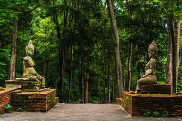 Obraz premium Ancient buddha figures Wat Umong Suan Puthatham is a Buddhist temple in the historic centre and is a Buddhist temple is a major tourist attraction with green forest nature in Chiang Mai,Thailand.