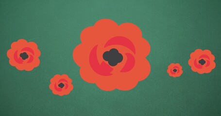 Composition of red flowers on green background