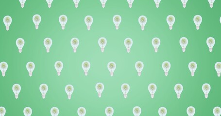 Composition of multiple trees in light bulbs repeated in grid over green background