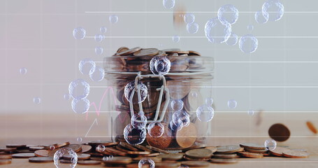 Multiple bubbles floating over financial data processing against multiple coins falling in glass jar