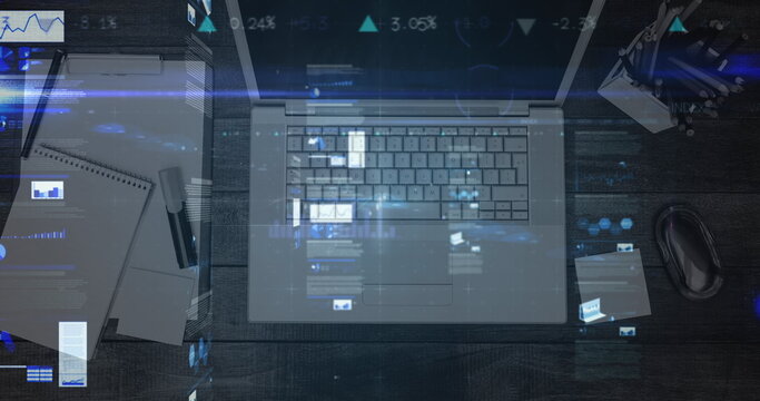 Statistical data processing against overhead view of laptop and office equipment on wooden desk