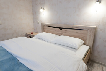 Large bed with crisp white linens and pillows 