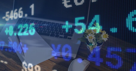 Image of financial data processing over desk with notebook and laptop