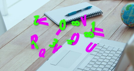 Image of numbers and letters changing over desk with laptop and notebook