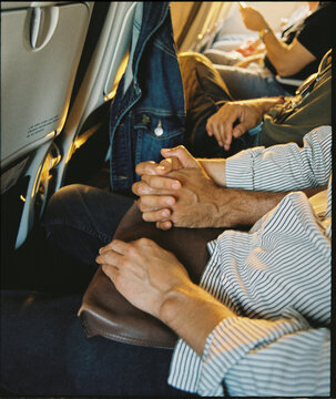 holding hands in an airplane