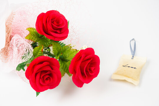 three red rose flower in bunch with love bag on white background