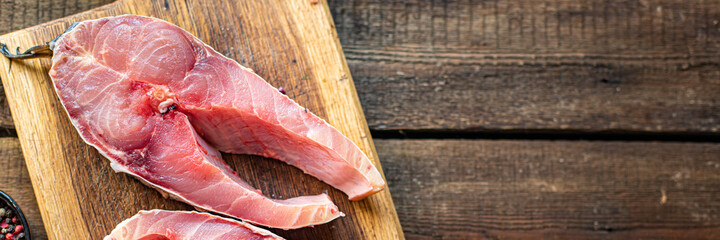 fresh raw fish carp white fish headless carcass meal snack on the table copy space food background rustic. top view keto or paleo diet pescetarian