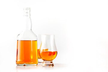 Scotch Whiskey in special glasses and bottle, white background with negative space