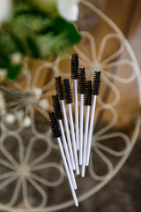 eyebrow brush on a transparent table, top view