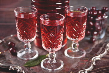 glasses of cherry brandy liqueur with ripe berries