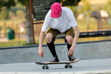 Fototapeta premium young skateboarder doing a trick at a skateboard park