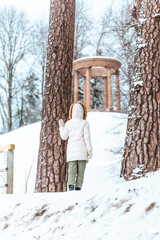 Women in white standing between pines with gorgeous view to Temple of Fame - granite rotunda.