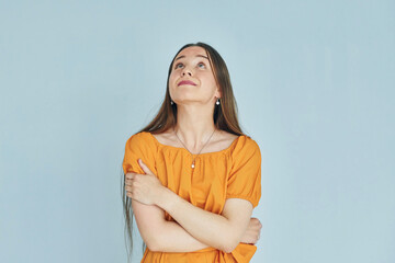 Have an idea. Young woman in casual clothes standing indoors in the studio