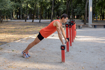 Fototapeta premium young athletic man goes in for sports in the park. outdoor fitness, healthy lifestyle