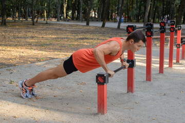 Fototapeta premium young athletic man goes in for sports in the park. outdoor fitness, healthy lifestyle