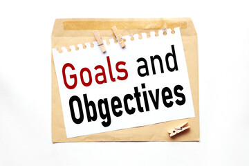 Goals and Objectives, text on paper on craft envelope on white background