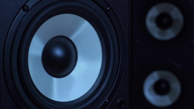This stock video features a close-up shot of a subwoofer producing different types of bass sound.