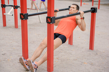 athletic young man doing different exercises outdoors