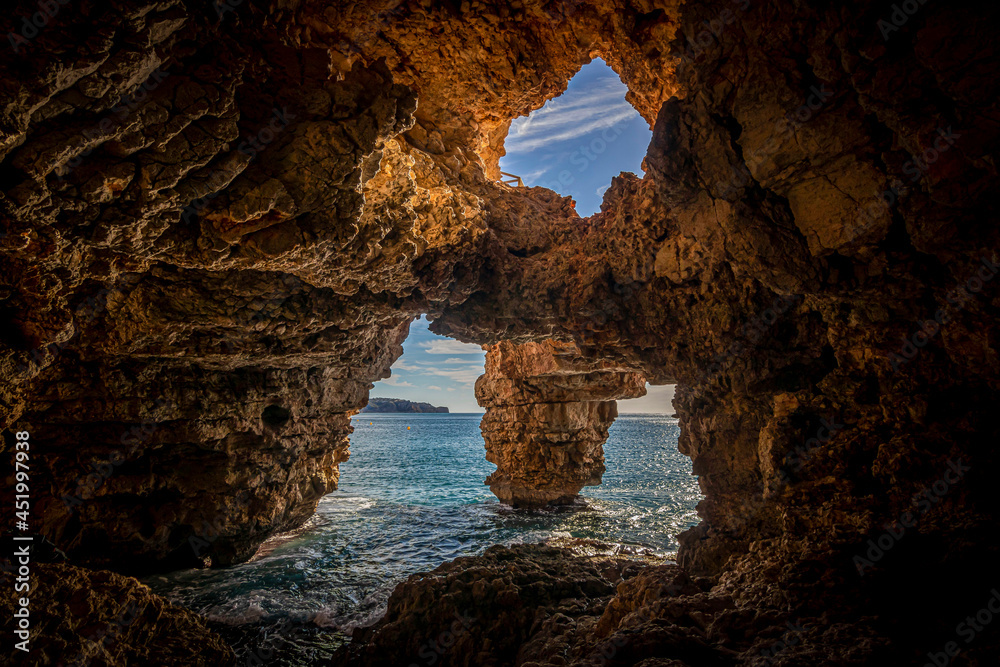 Wall mural natural cave on the coast in spain, benitatxell, alicante, cova dels arcs