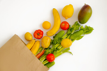 paper bag, vegetables and fruits on a white background