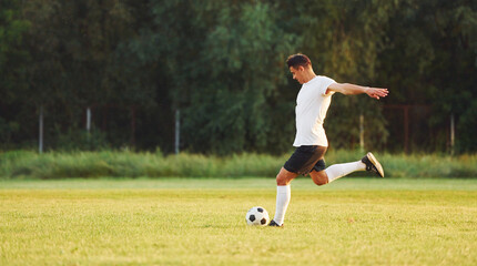 Professional practice. Young soccer player have training on the sportive field