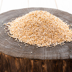 Raw dried broken barley cereal grain texture background macro closeup. Barley groats, coarse barley semolina.