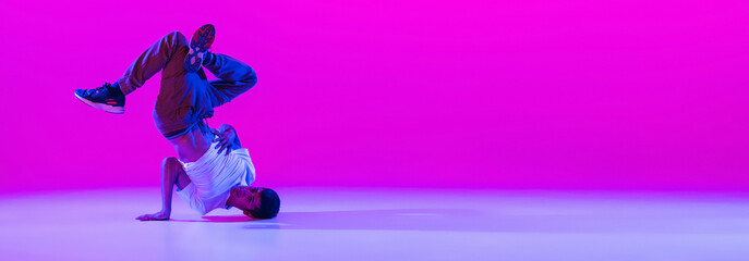 Flyer with dancing man, break dancer in action, motion in modern clothes isolated over bright...