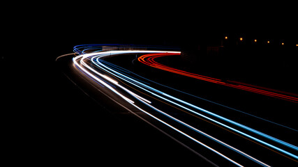 Fototapeta na wymiar Night road lights. Lights of moving cars at night. long exposure multicolored