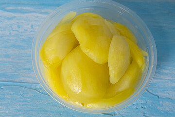 close up of iced yellow pickled mangoes, dessert in Thailand
