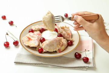 Concept of tasty eating with pierogi with cherry