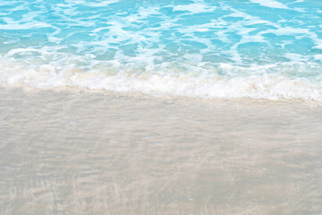 Fototapeta na wymiar Close up Soft beautiful ocean wave on sandy beach for background